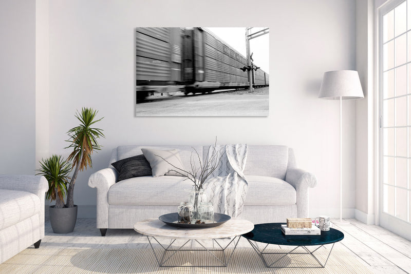 Metal Art Print - A blurred motion photograph of a train at a railroad crossing.